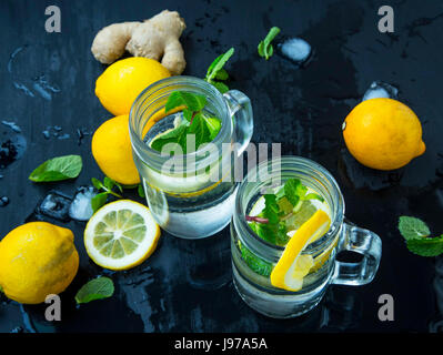 Mojito cocktails frais lunettes avec de la menthe fraîche et des citrons sur fond de bois foncé Banque D'Images