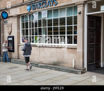 Un homme à l'aide d'un guichet automatique à l'extérieur de la succursale de la banque Barclays à Guisborough,Angleterre,UK Banque D'Images