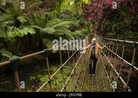 Royaume-uni l'Angleterre, dans le Dorset, Abbotsbury, sous les jardins tropicaux, les hauts de passage des visiteurs sur l'étang du pont de corde Banque D'Images