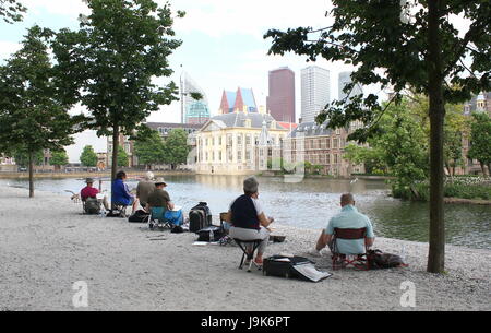 Peintres amateurs s'asseoir pour peindre les toits de Den Haag (La Haye), aux Pays-Bas. Hofvijver, à l'étang vers Binnenhof, le parlement néerlandais. Banque D'Images