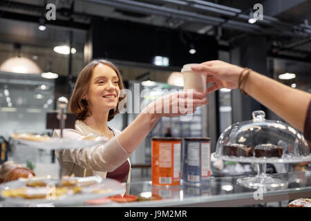 Happy woman taking Coffee cup du vendeur à cafe Banque D'Images