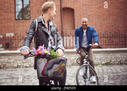 Couple avec course de vélos sur la rue pavée Banque D'Images