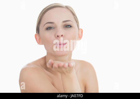 Libre de cute young woman blowing a kiss over white background Banque D'Images