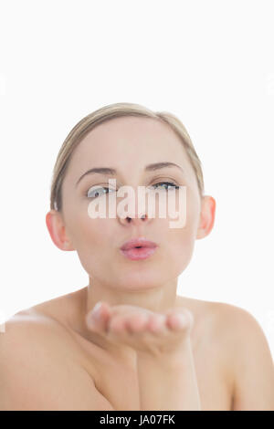 Libre de cute young woman blowing a kiss over white background Banque D'Images