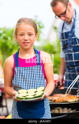 Repas en famille dans le jardin en face de la maison Banque D'Images