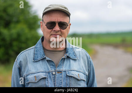 Outdoor portrait of mature man in black lunettes Banque D'Images