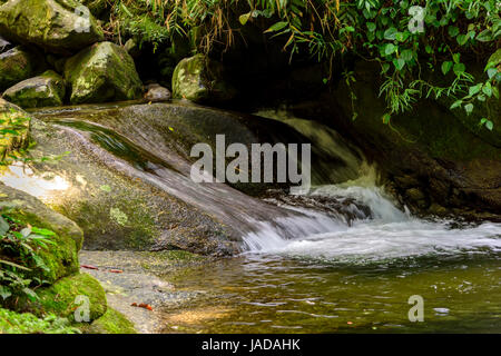 Petite rivière et cascade entre les roches du Parc National d'Itatiaia à Penedo, Rio de Janeiro Banque D'Images