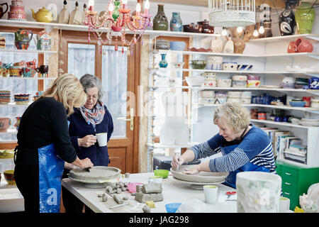 Trois femmes dans un atelier de poterie le travail de l'argile. Banque D'Images