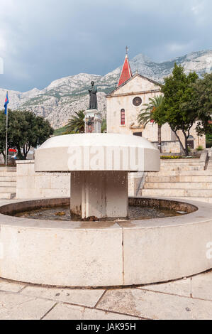 Fontaine en face de l'église de Saint Marc sur place Kaciceva, Makarska, Croatie. Banque D'Images