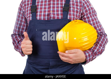 Close up photo d'un jeune ingénieur homme tenant son casque, showing Thumbs up Banque D'Images