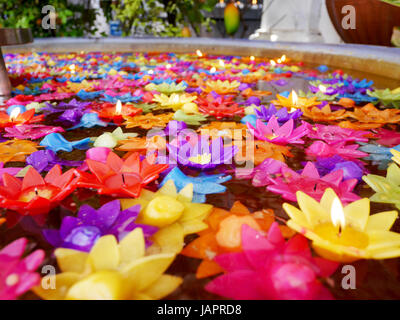 La prière rituelle de bougies colorées flottant sur l'eau pour prier bouddha à Wat Phra Pathommachedi Ratcha Wora Wihan Maha dans Nakhon Pathom, Thaïlande Banque D'Images