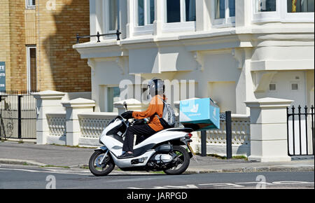 Deliveroo la livraison de restauration rapide rider sur un scooter Photo prise par Simon Dack Banque D'Images