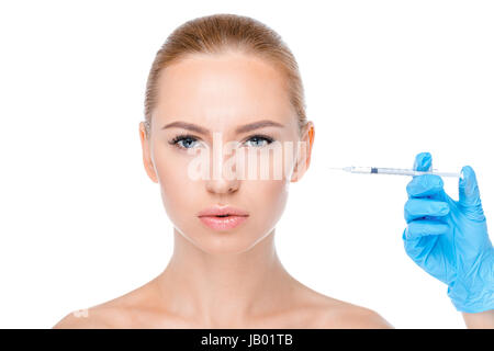 Portrait of serious woman getting botox injection on white Banque D'Images