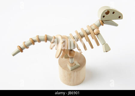 En bois dinosaure jouet articulé isolé sur blanc. L'horizontale Banque D'Images