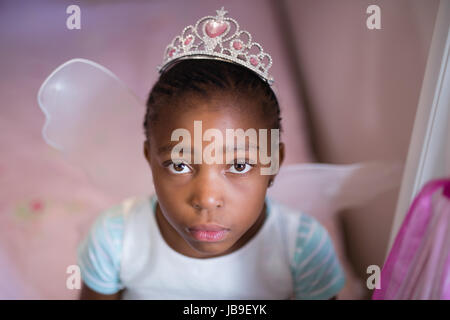 High angle view of serious little girl wearing costume fée Banque D'Images