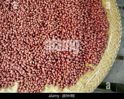 Gros plan d'une partie d'un grand panier rond plat plein d'arachides à l'état naturel Banque D'Images