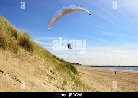 Para planeurs volant au-dessus des dunes de la côte et d'avoir un grand temps. Banque D'Images