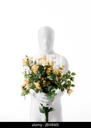 Homme sans visage blanc habillé avec un bouquet de roses dans la main Banque D'Images