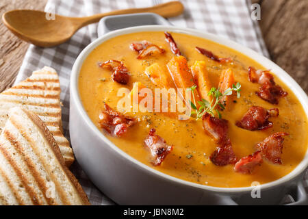 Soupe de patates douces au bacon et les herbes dans une casserole macro sur la table horizontale. Banque D'Images