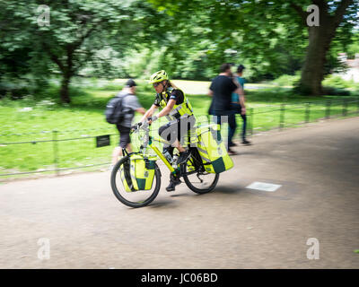 Un vélo ambulancier du service d'ambulance de Londres se précipite dans St James Park pour un appel avec des feux bleus qui clignotent. Vélo paramédic en mouvement. Banque D'Images
