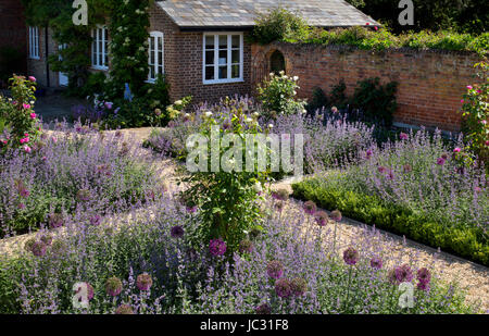 Chemin de gravier avec les pensionnaires de l'été des fleurs dans un jardin anglais Banque D'Images