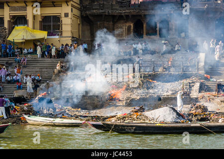 Fumée de cadavres incinérés augmente à manikarnika ghat au fleuve saint Ganges dans la banlieue godowlia Banque D'Images