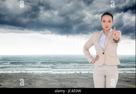 Composite image of businesswoman pointing Banque D'Images