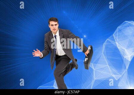 Image composite de stern attractive businessman dans un hury Banque D'Images