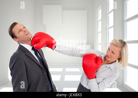 Image composite de businesswoman boxing gloves Banque D'Images