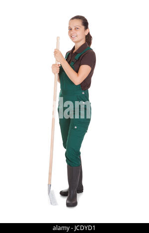 Jeune femme Gardner avec les outils de jardinage sur fond blanc Banque D'Images