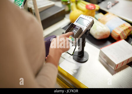 Femme d'entrer code pin par store cash register Banque D'Images