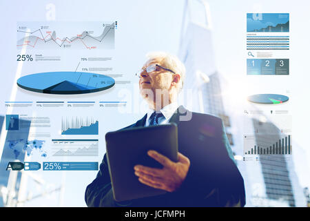 Senior businessman with tablet pc on city street Banque D'Images