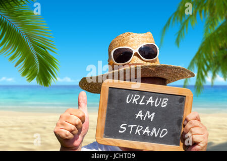 Der Mann mit Tafel Texte : Urlaub am Strand Banque D'Images