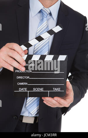 Portrait of Mid adult businessman holding deck over white background Banque D'Images