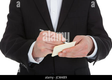 Portrait waiter writing on notepad isolé sur fond blanc Banque D'Images