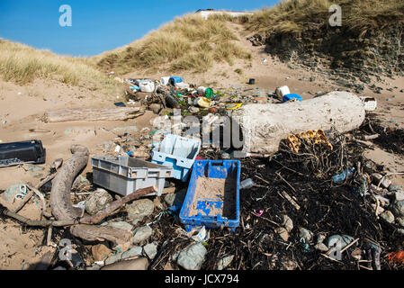 Une variété de flotsam & jetsom y compris la corde emmêlées, de compensation et d'objets en plastique échoué sur une plage sur la côte ouest d'Anglesey en Galles du Nord. Banque D'Images