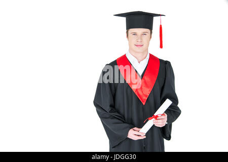 Smiling young man in graduation hat holding diploma on white Banque D'Images