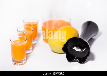 Fruits tropicaux de jus de mangue avec des verres et des mangues avec mixeur isolé sur fond blanc belle photo photographie alimentaire Banque D'Images