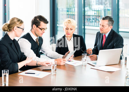 Entreprise - réunion de bureau, le ou les avocats d'affaires de l'équipe discutent dans un document sur l'ordinateur portable Banque D'Images