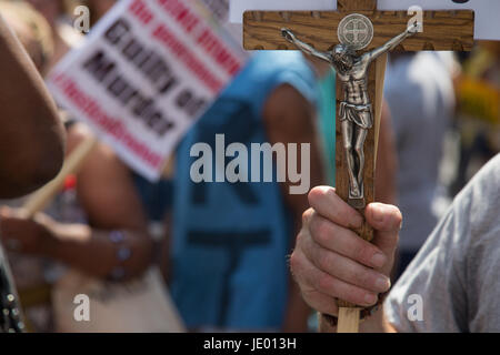 Londres, Royaume-Uni. 21 Juin, 2017. Un homme porte une croix de Jésus Christ pendant une manifestation de protestation contre le gouvernement à l'occasion de l'ouverture du Parlement de l'État et à la suite de l'incendie mortel à tour de Grenfell. Credit : Thabo Jaiyesimi/Alamy Live News