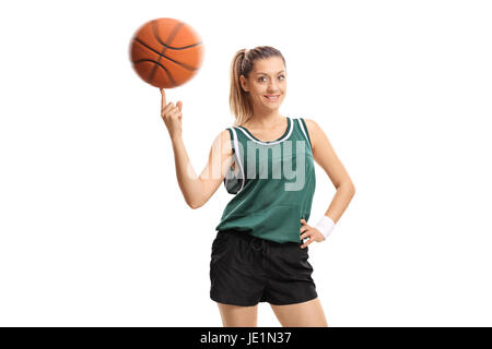 Jeune femme de tourner un ballon de basket sur son doigt isolé sur fond blanc Banque D'Images