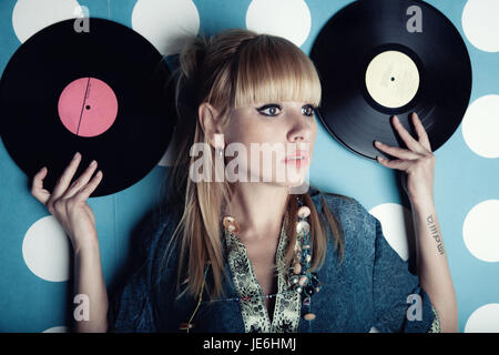 Portrait d'une belle jeune femme blonde avec des disques de vinyle dans les mains.de la musique, de la mode Thème Banque D'Images