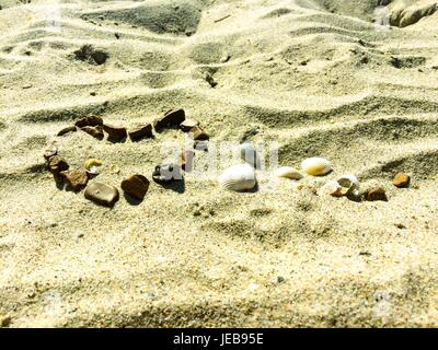 Coeur signe sur un sable fait de pierres Banque D'Images