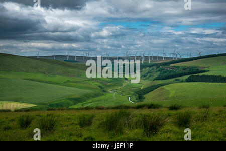 Une vue lointaine sur une vallée et la campagne vers une grande ferme d'éoliennes en région des Scottish Borders et East Lothian, Scotland, UK Banque D'Images