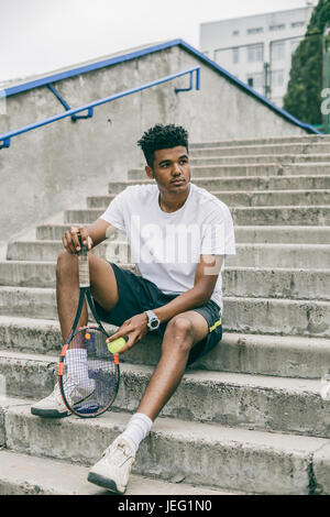 Portrait of African man est assise sur des mesures concrètes Banque D'Images