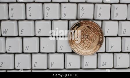 La monnaie numérique or physique bitcoin titan sur blanc clavier de l'ordinateur. Banque D'Images