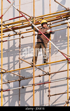 WEIHAI-CHINE-déc. 4, 2006. Travailleur chinois sur l'échafaud . La Chine 200 millions de travailleurs migrants des zones rurales vers les grandes villes pour trouver du travail. Banque D'Images