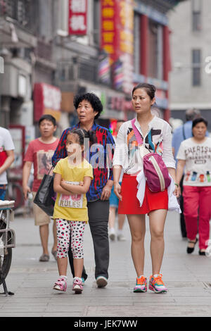 PÉKIN-9 JUIN 2015. Jeune femme avec fille et mère. Pour aider leurs enfants, il faut souvent jouer un rôle actif dans la collecte de petits-enfants. Banque D'Images