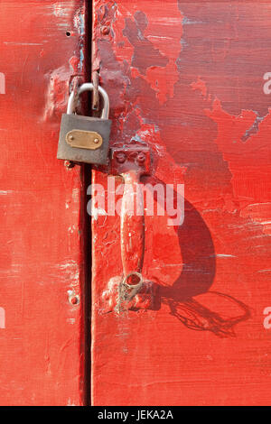 Vieille porte peinte rouge avec cadenas Banque D'Images