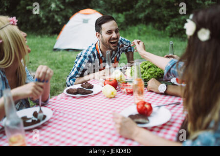 Woman sitting at table et having meal in nature Banque D'Images